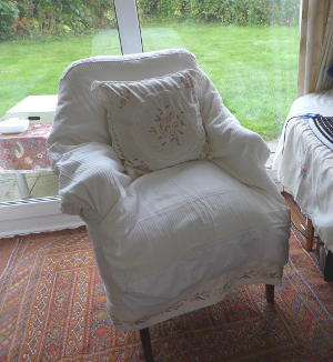Cream chair with flower border and cushion
