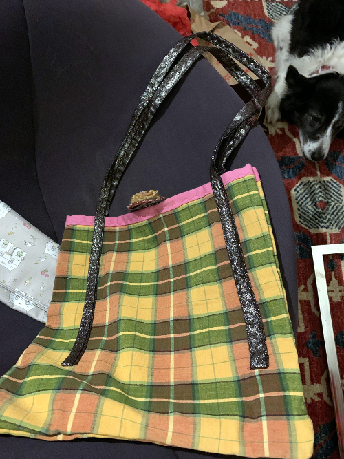 Plaid bag with floral brooch