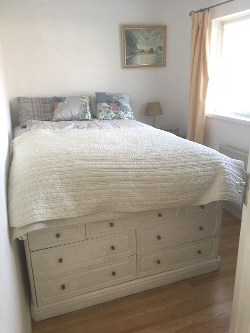 Bedroom with upcycled storage bed, vintage art and handmade cushions Interior by A Howse