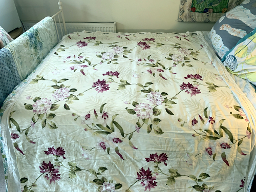 Using bed to layout fabric while painting Garden Studio